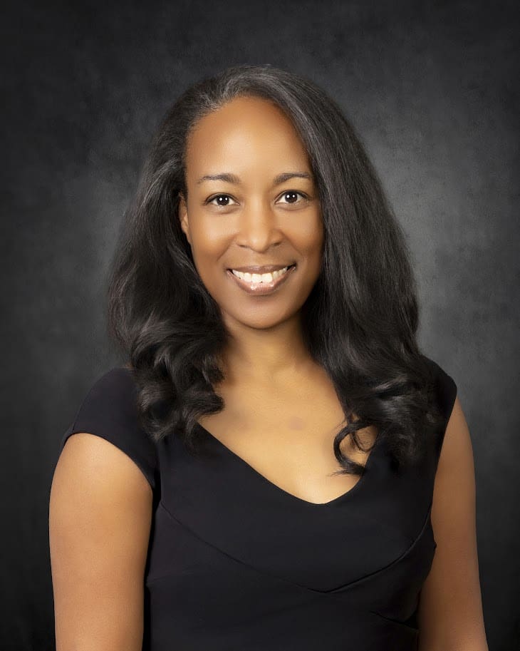 Smiling woman in black dress studio portrait