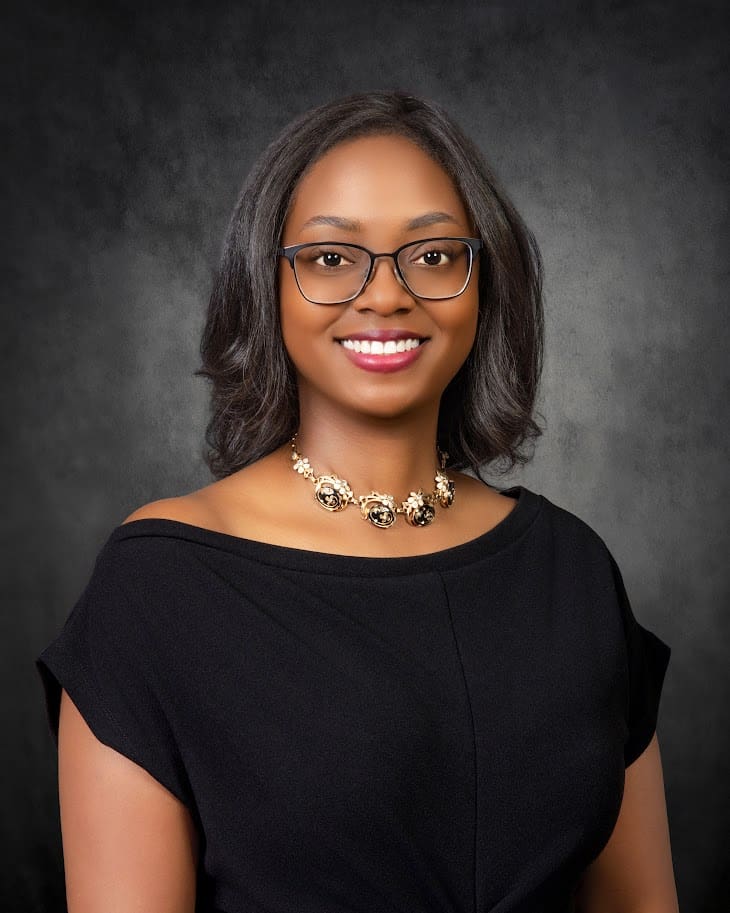 Smiling woman with glasses and statement necklace